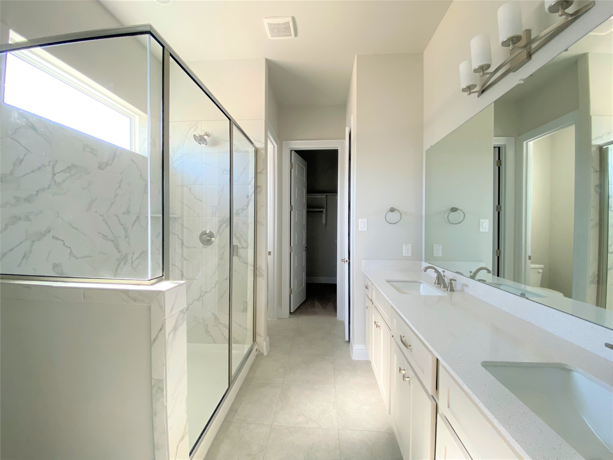 600 C-Bar Ranch Trail, Unit 105 Cedar Park, TX 78613 - Photo 6 of 12 Full bathroom with double vanity, a marble finish shower, and a walk in closet