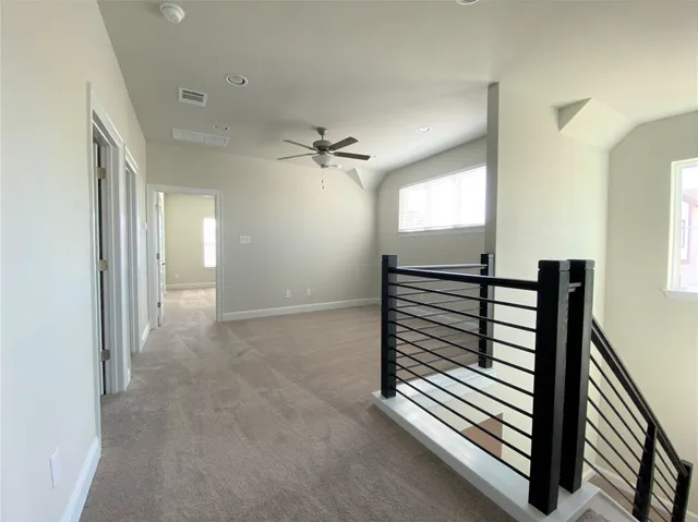 an empty room with a empty space and windows