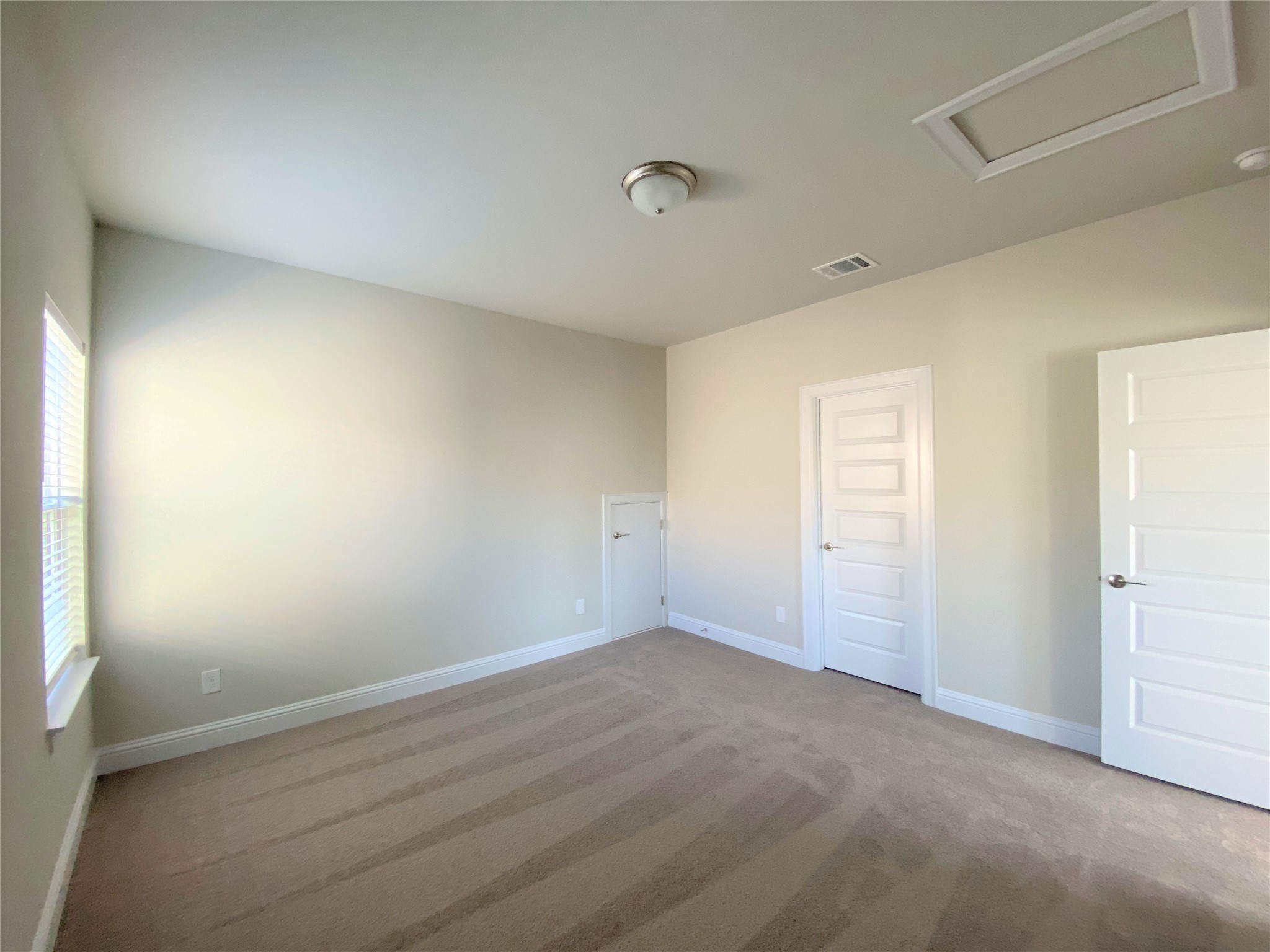 600 C-Bar Ranch Trail, Unit 105 Cedar Park, TX 78613 - Photo 9 of 12 Unfurnished bedroom featuring attic access and light colored carpet