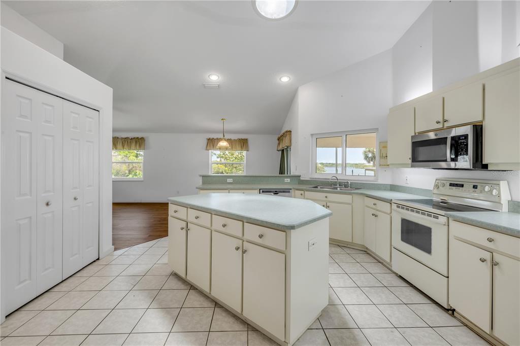 192 Azalea Road Edgewater, FL 32141 - Photo 43 of 94 a kitchen with a stove sink and cabinets