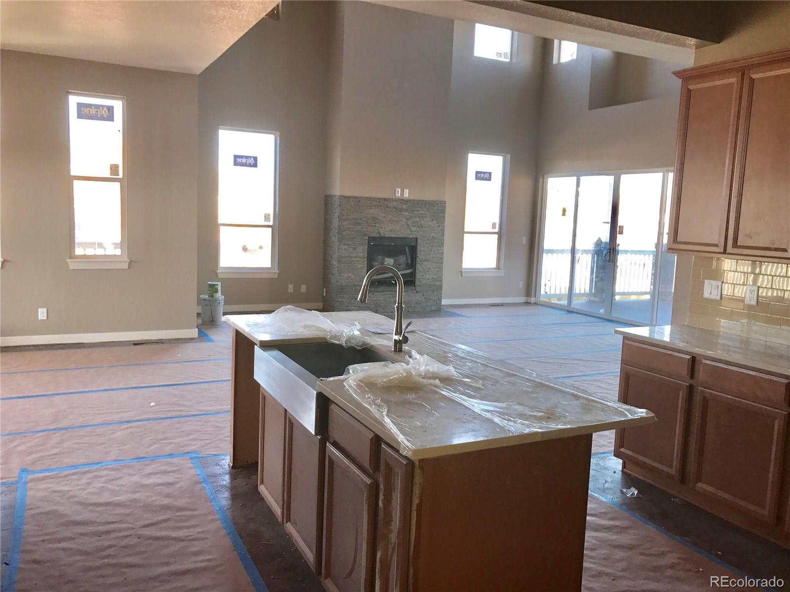 4378 Fell Mist Way Castle Rock, CO 80109 - Photo 9 of 18 a kitchen with a sink and wooden cabinets