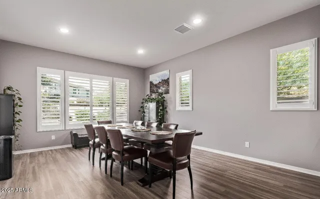 a view of a dining room with furniture and windows