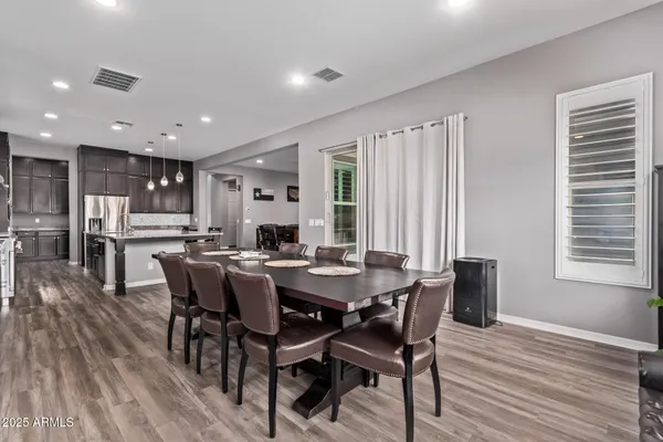 a view of a dining room with furniture and windows