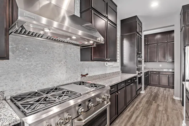 a kitchen with stainless steel appliances granite countertop a stove and a refrigerator