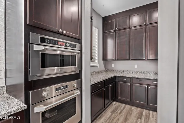 a kitchen with stainless steel appliances granite countertop a refrigerator and a sink