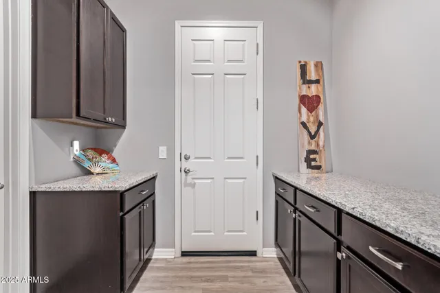 a bathroom with a granite countertop sink toilet a mirror a vanity and shower