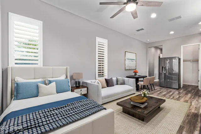 a bedroom with a large bed and a chandelier