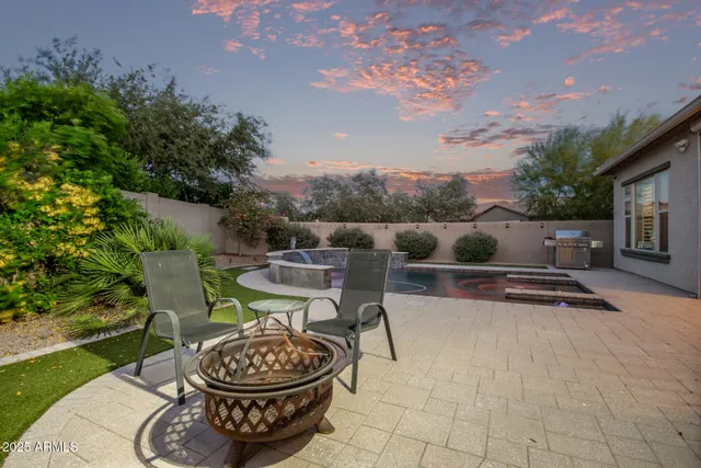 a view of a house with swimming pool and sitting area