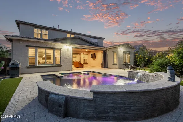 an aerial view of residential houses with outdoor space and mountains
