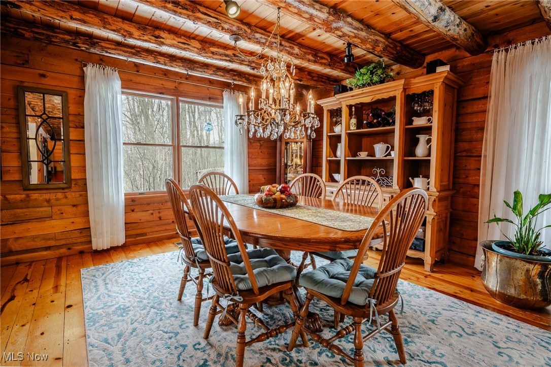 3421 Ridge Road Northwest Bolivar, OH 44612 - Photo 8 of 45 Dining space with light wood-style floors, wood ceiling, a notable chandelier, and beam ceiling
