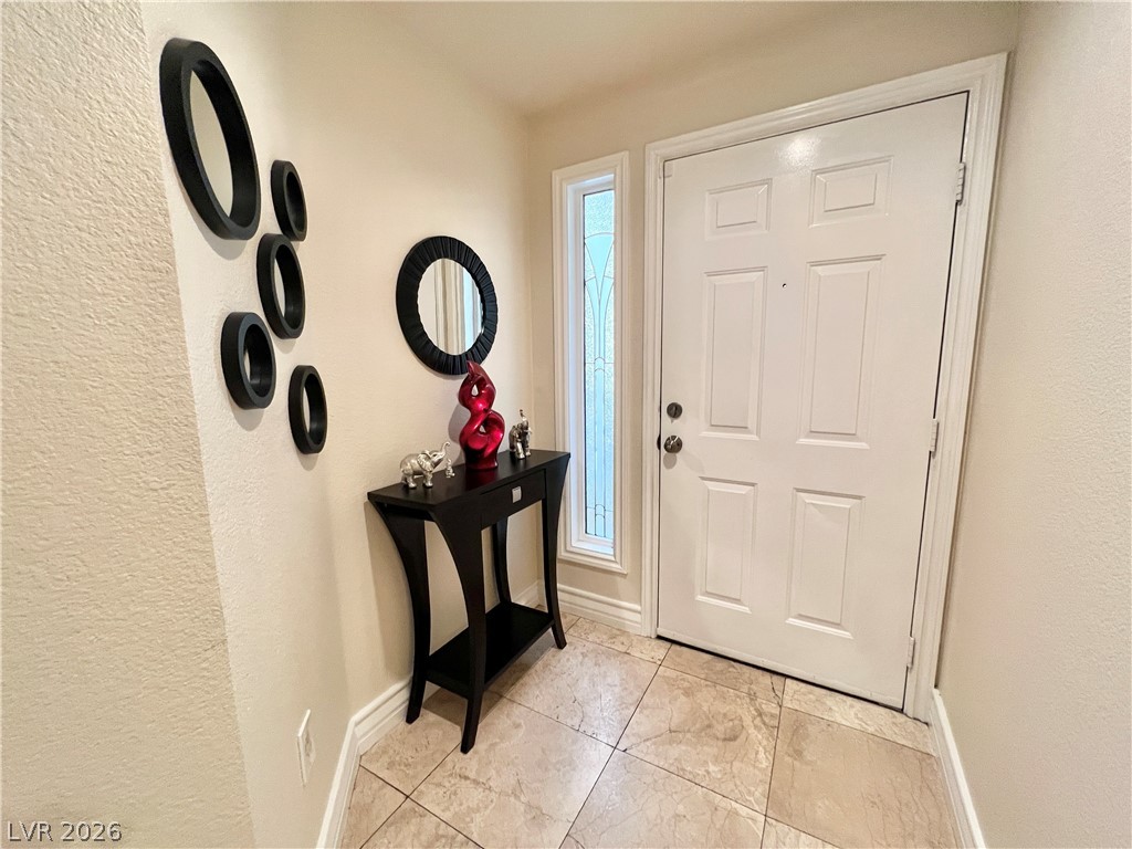 270 East Flamingo Road, Unit 313 Las Vegas, NV 89169 - Photo 8 of 27 Enter into a welcoming foyer with elegant tiled flooring and a bright entryway.