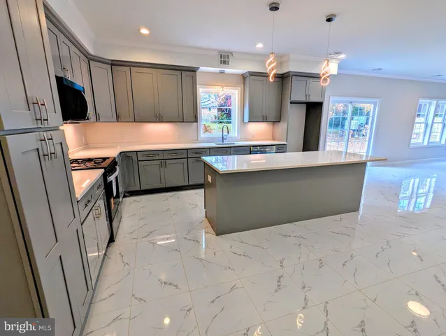 a kitchen with stainless steel appliances a sink and a refrigerator