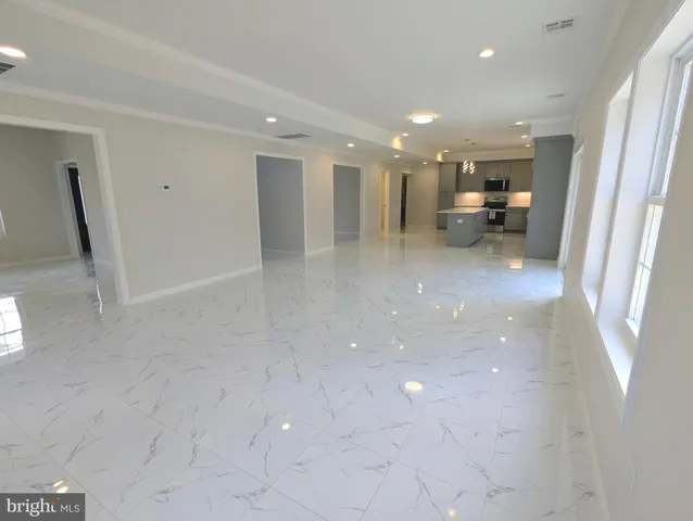 a view of a hallway to a room with a furniture