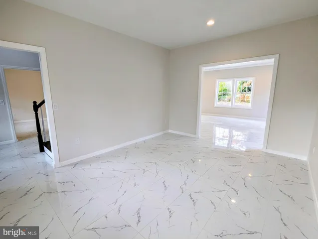 a view of an empty room and a window
