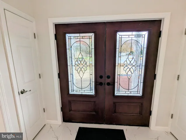 view of room with window and hallway