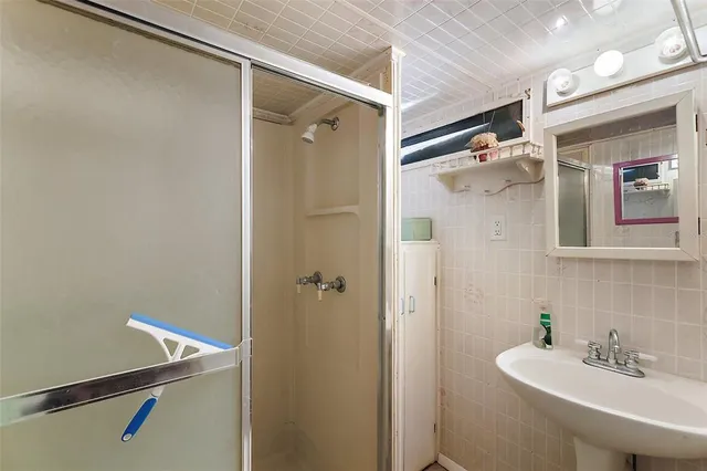 a bathroom with a sink and shower