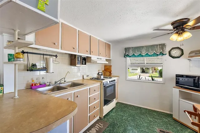a kitchen that has a sink and a stove