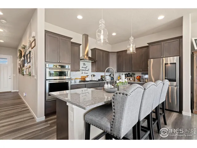 a kitchen with kitchen island a refrigerator stove and center island