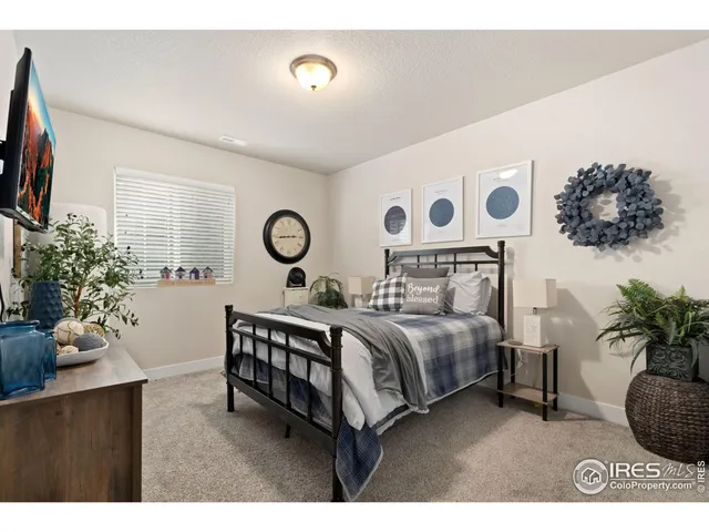 a spacious bedroom with a bed and a window