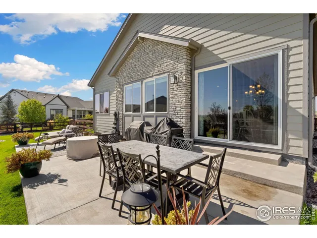 a view of a patio with table and chairs