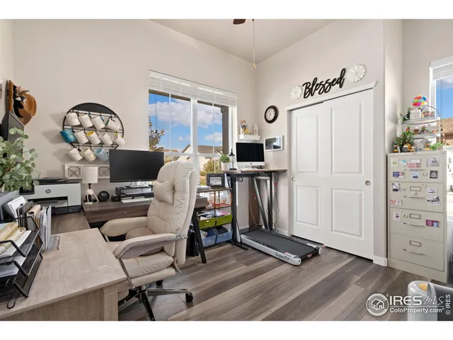 a living room with furniture a fireplace and gym equipment
