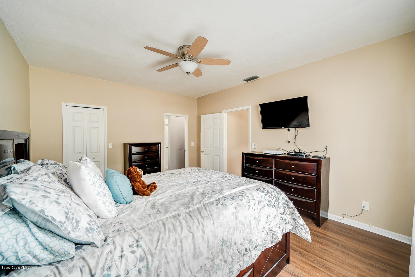 155 Bluff Terrace Melbourne, FL 32901 - Photo 11 of 20 a bedroom with a bed and a flat screen tv