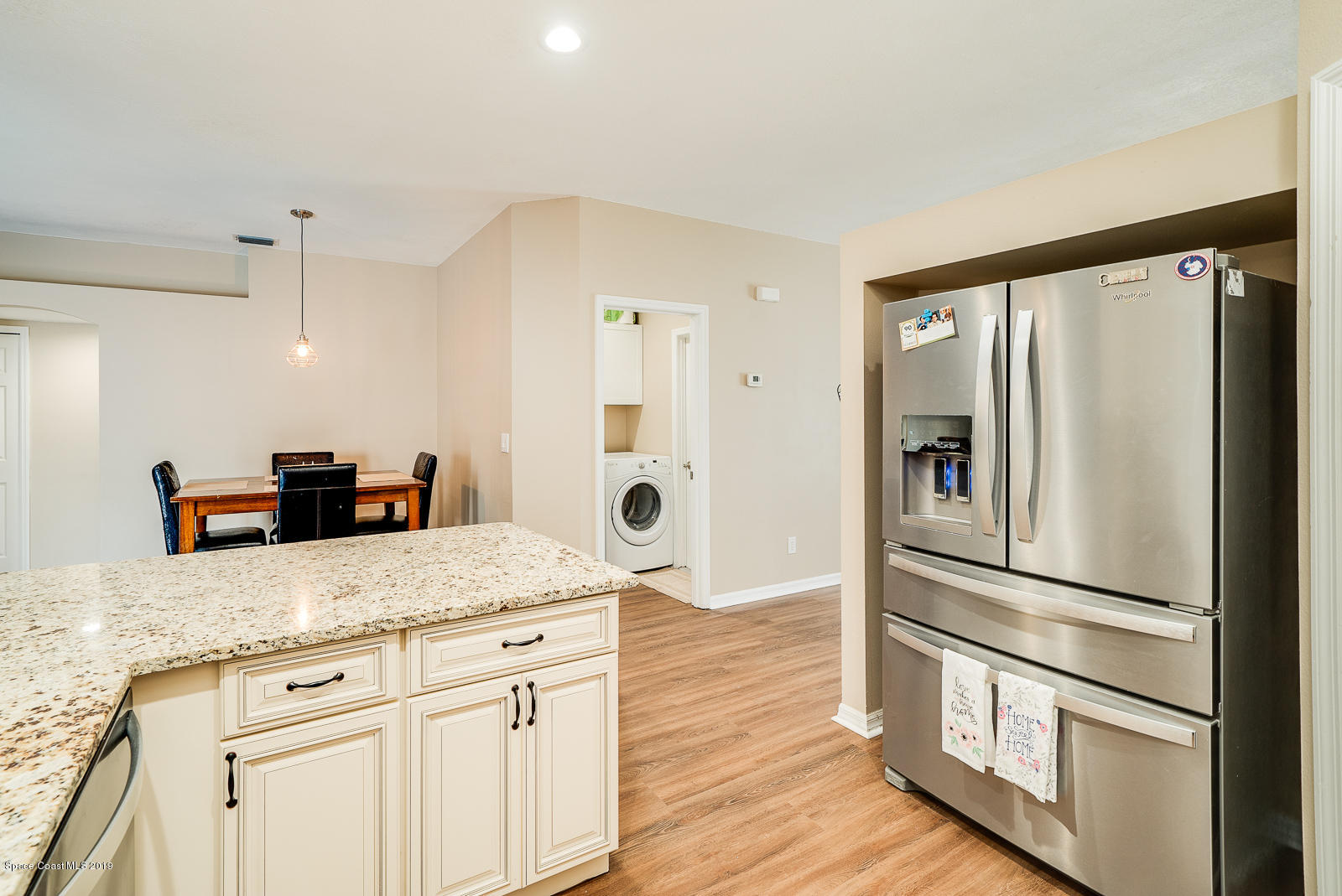 155 Bluff Terrace Melbourne, FL 32901 - Photo 4 of 20 a kitchen with granite countertop appliances a counter space and wooden floor