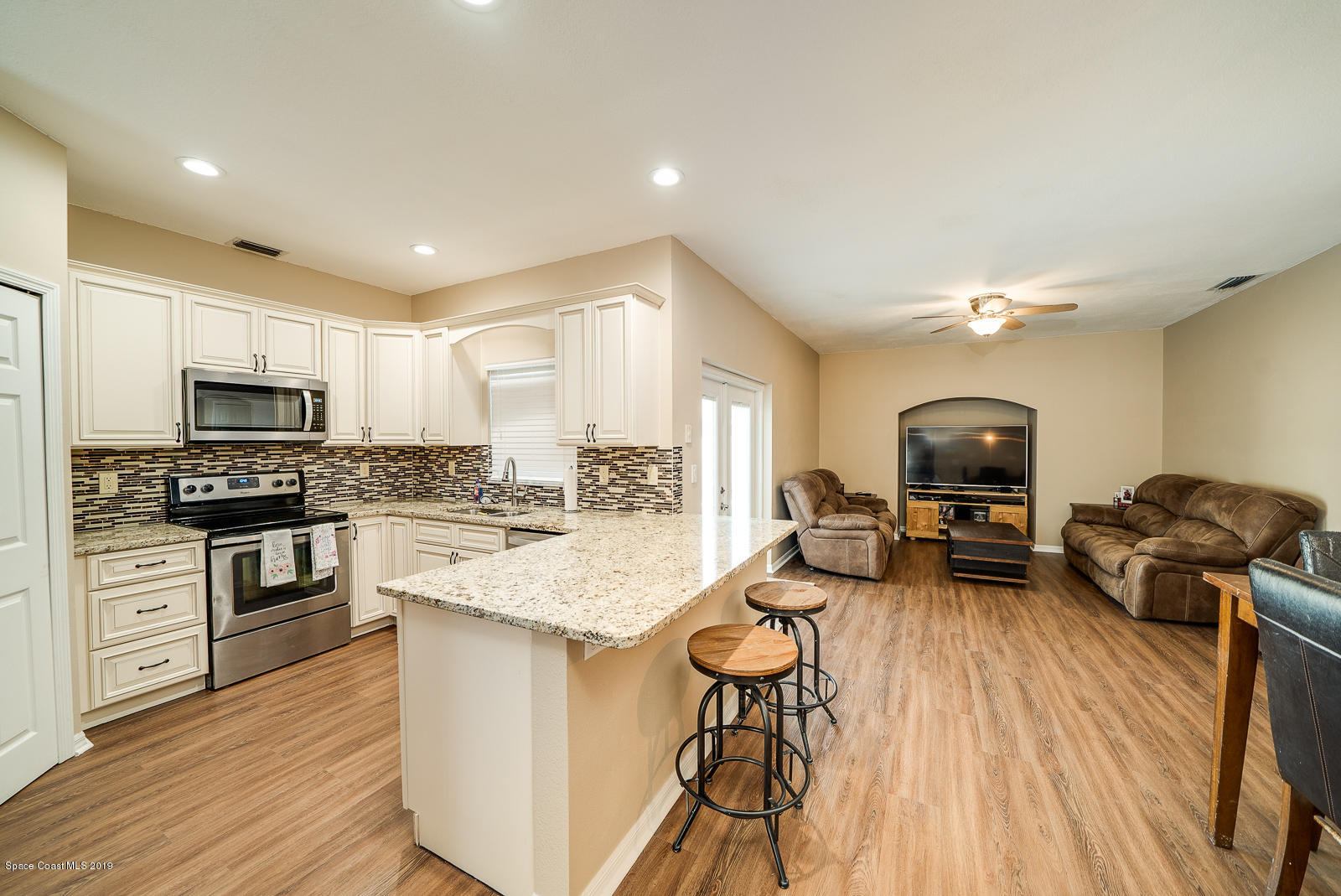 155 Bluff Terrace Melbourne, FL 32901 - Photo 5 of 20 a kitchen with sink refrigerator and stove