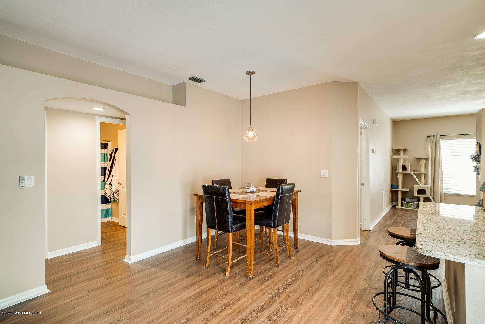 155 Bluff Terrace Melbourne, FL 32901 - Photo 8 of 20 a view of a dining room with furniture and wooden floor