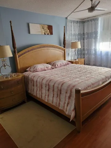 a bedroom with two beds and painting on the wall