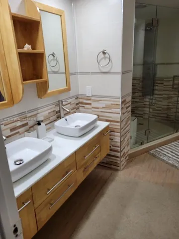 a kitchen with a table chairs and a refrigerator