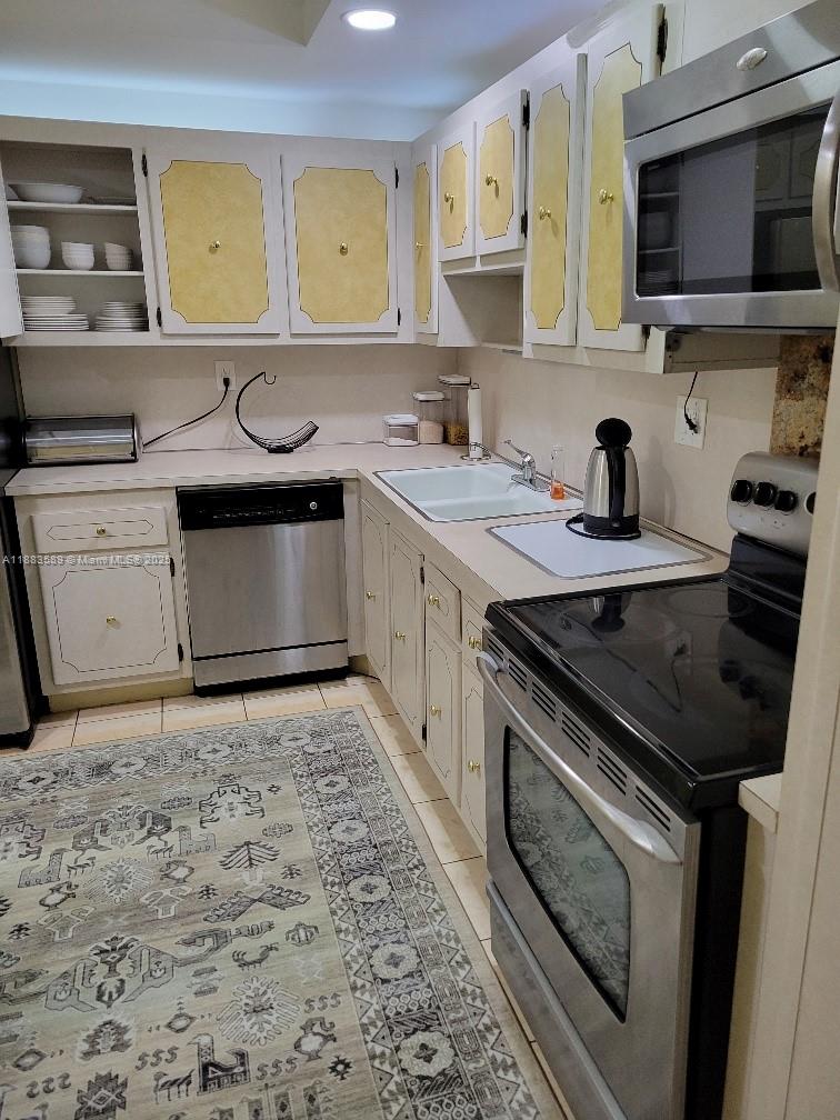 1833 South Ocean Drive, Unit 307 Hallandale Beach, FL 33009 - Photo 18 of 19 a kitchen with a stove and a sink