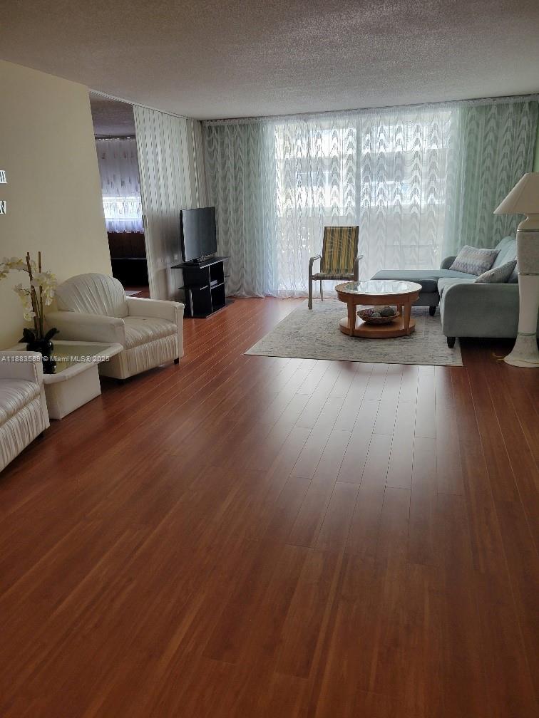 1833 South Ocean Drive, Unit 307 Hallandale Beach, FL 33009 - Photo 6 of 19 a living room with furniture and a large window