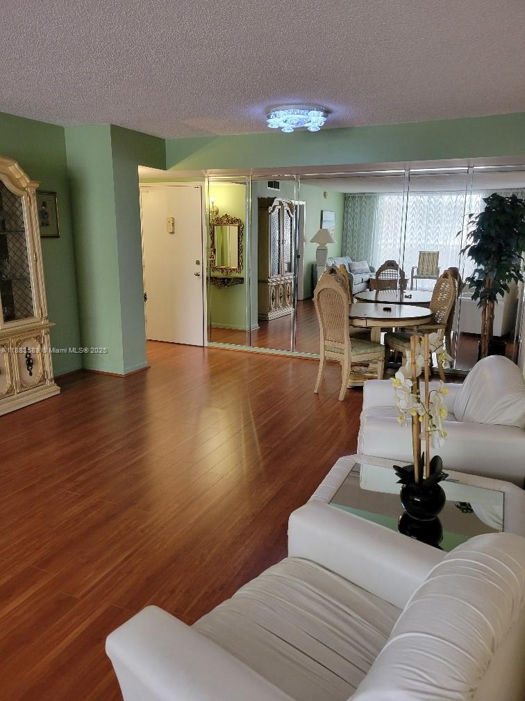 1833 South Ocean Drive, Unit 307 Hallandale Beach, FL 33009 - Photo 7 of 19 a living room with furniture a wooden floor and a fireplace