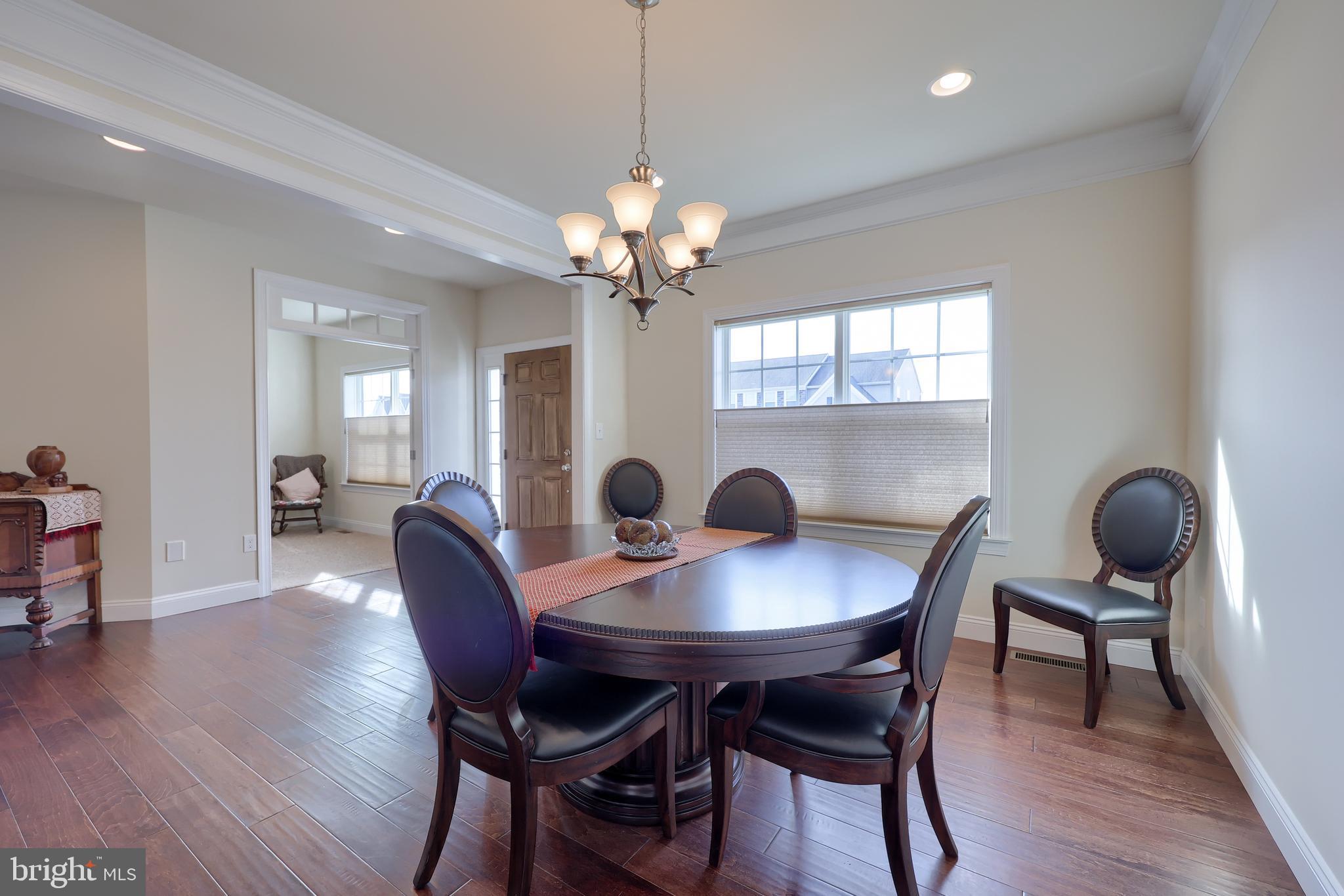 640 Warminster Lane Lititz, PA 17543 - Photo 10 of 57 a view of a dining room with furniture a chandelier and wooden floor