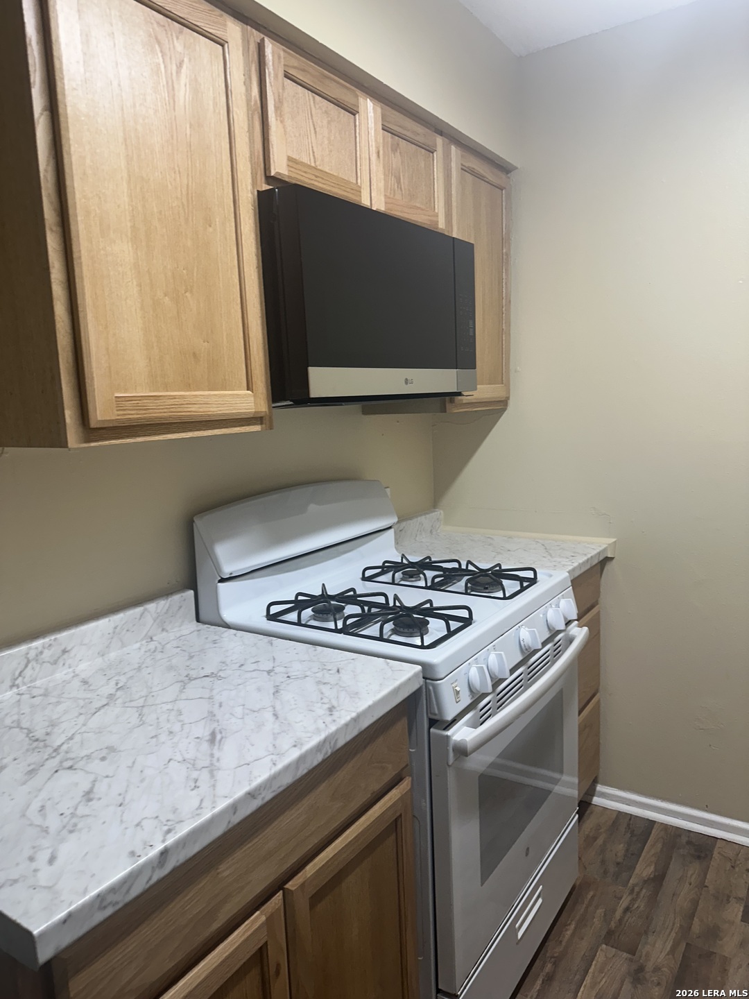 2129 Pat Booker Road, Unit 2 Universal City, TX 78148 - Photo 2 of 8 a kitchen with a stove and a microwave