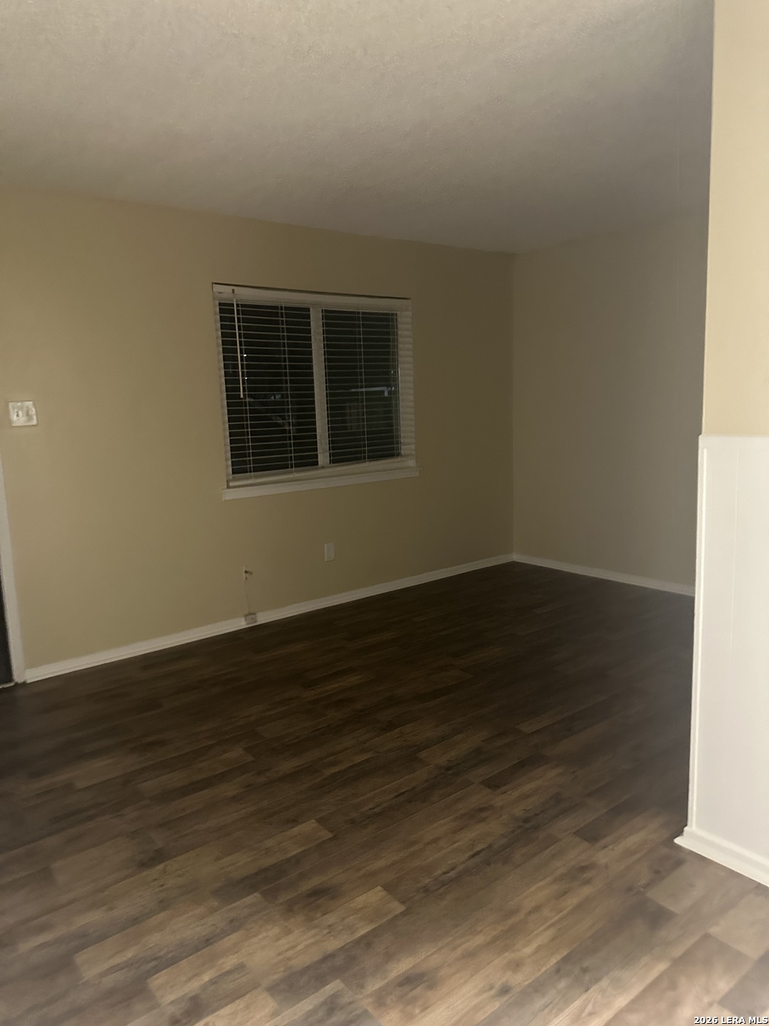 2129 Pat Booker Road, Unit 2 Universal City, TX 78148 - Photo 4 of 8 a view of an empty room with wooden floor and a window