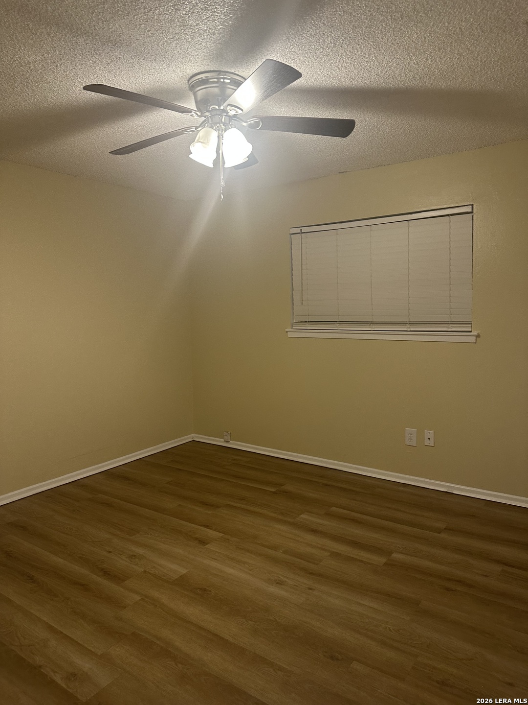 2129 Pat Booker Road, Unit 2 Universal City, TX 78148 - Photo 7 of 8 a view of an empty room with wooden floor