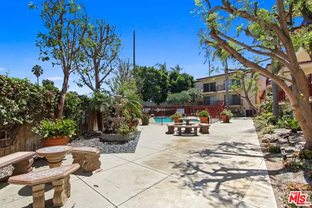 a view of a patio with table and chairs and potted plants