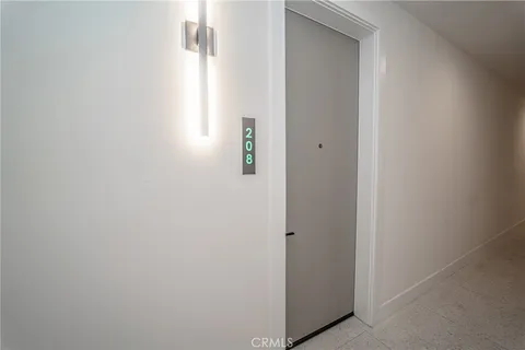 a kitchen with granite countertop white cabinets and stainless steel appliances
