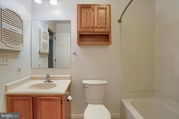 a bathroom with a sink a toilet and tub