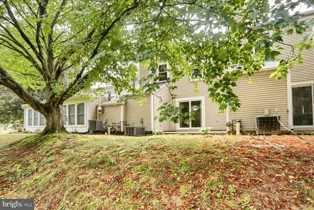a large house with trees in front of it