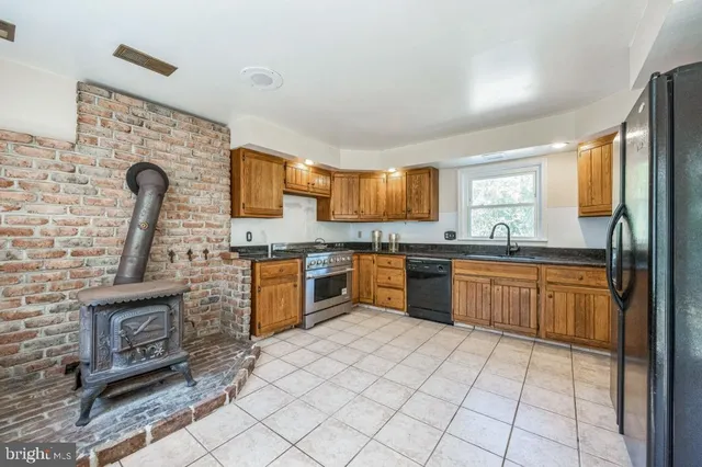 a kitchen with stainless steel appliances granite countertop a stove sink and cabinets