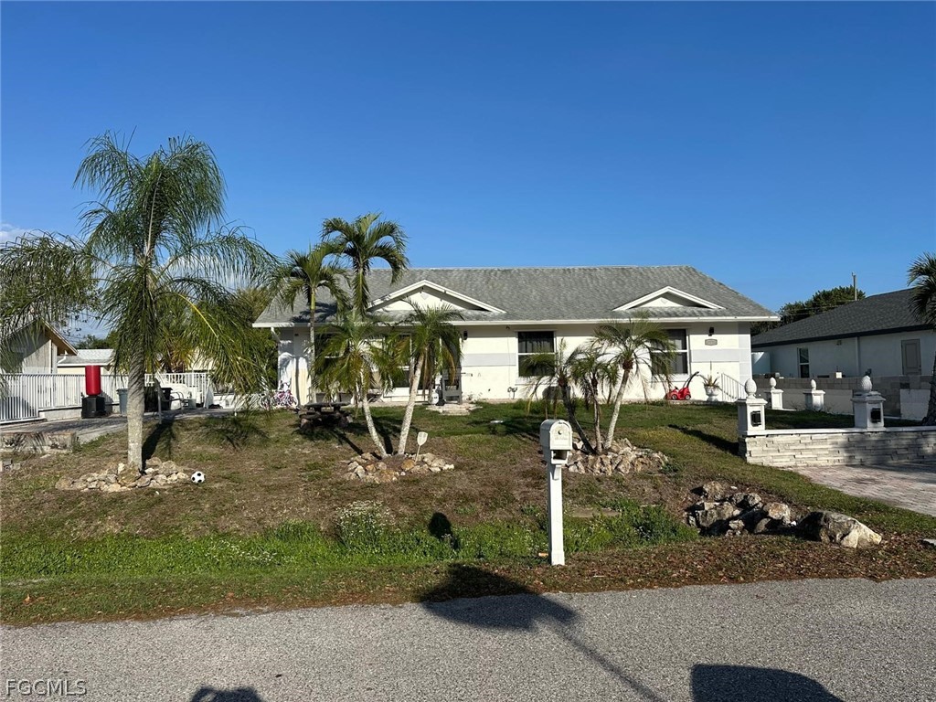19751 Adams Road Fort Myers, FL 33908 - Photo 2 of 6 a front view of a house with garden