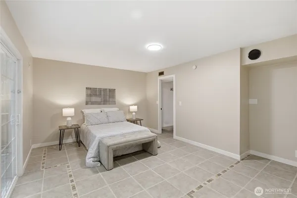 a bedroom with a bed and lamp