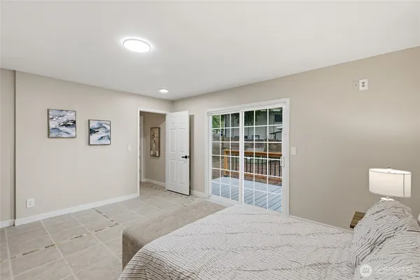 a bedroom with a large bed and a window