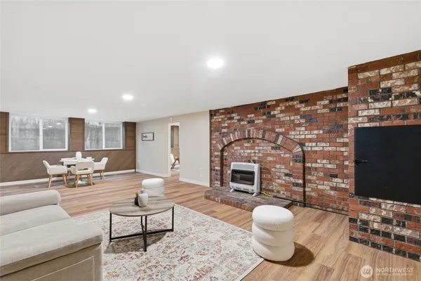 a living room with furniture a flat screen tv and a fireplace