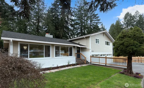a view of a house with a yard and porch