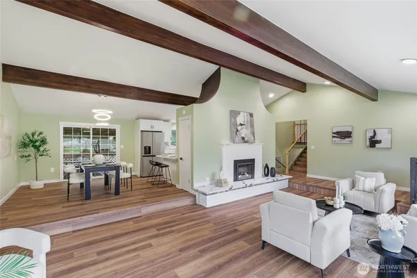 a living room with fireplace furniture and a wooden floor