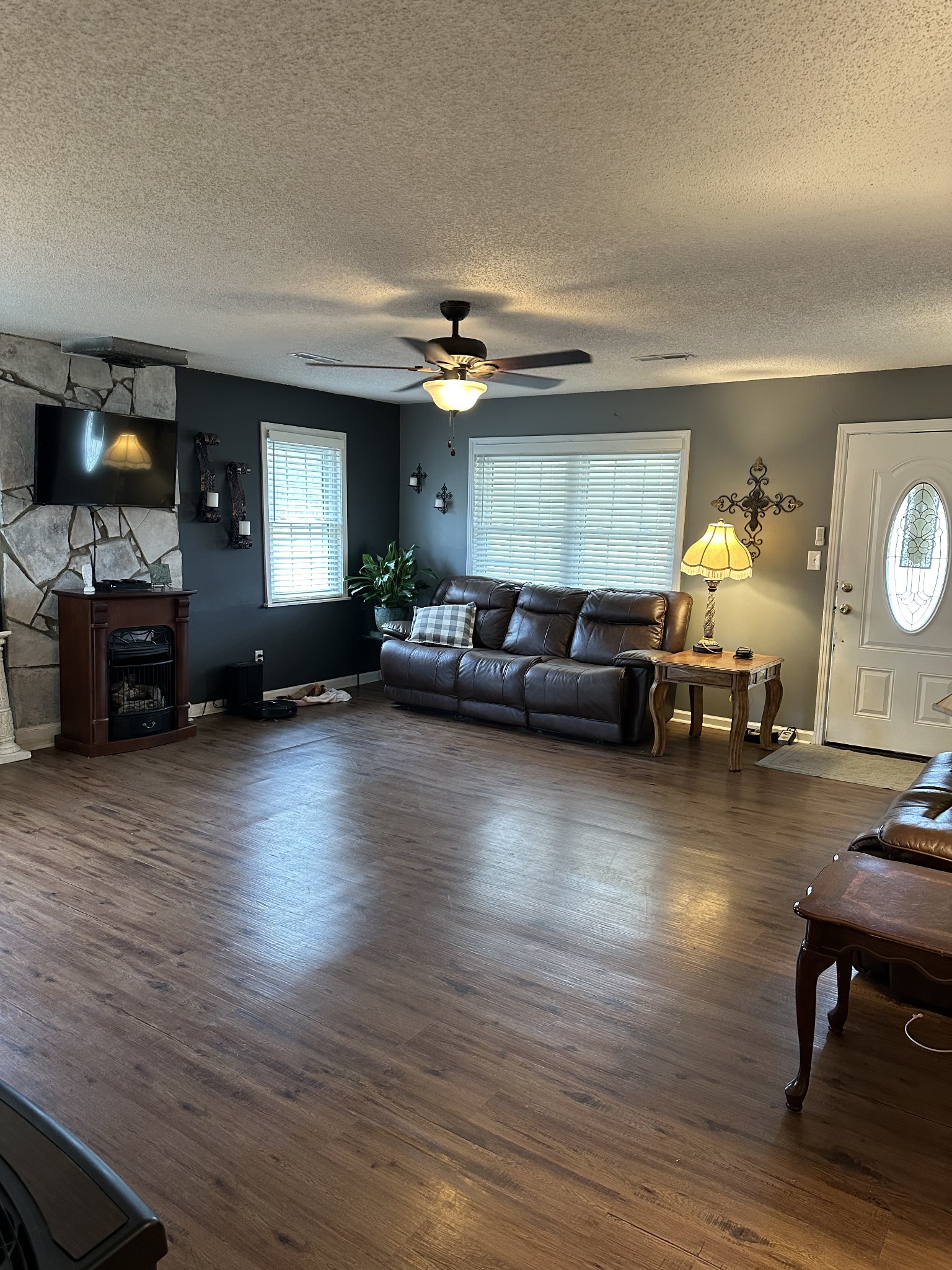 a living room with furniture and wooden floor